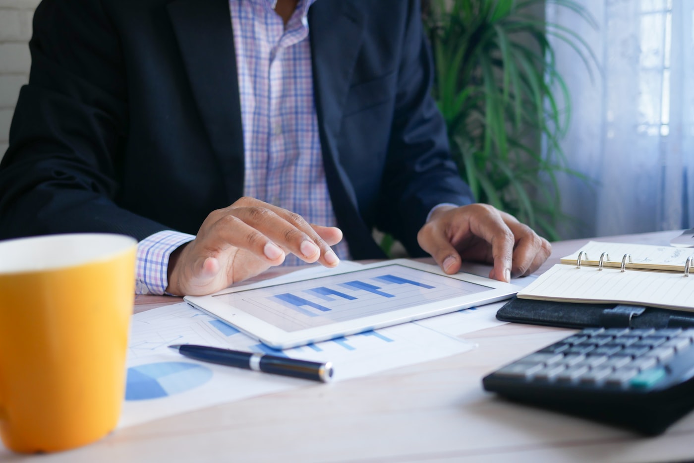A financial specialist reviewing retirement account paperwork at a desk