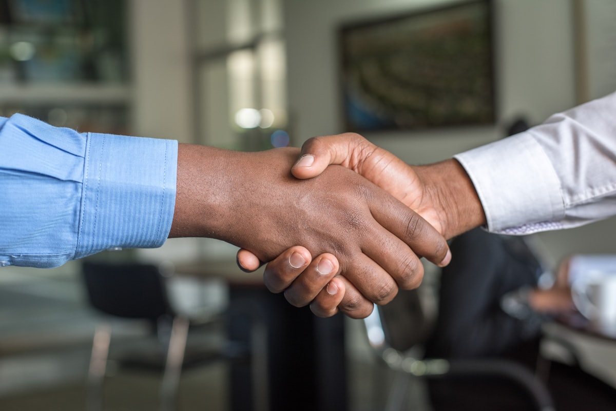 A Bullionite Asset Group specialist shaking hands with a client