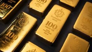 Rows of Scottsdale Mint 100-troy-ounce gold bars stamped 9999 fine gold