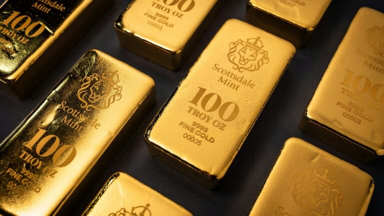 Rows of Scottsdale Mint 100-troy-ounce gold bars stamped 9999 fine gold